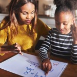 Mother and daughter doing homework learning to calculate