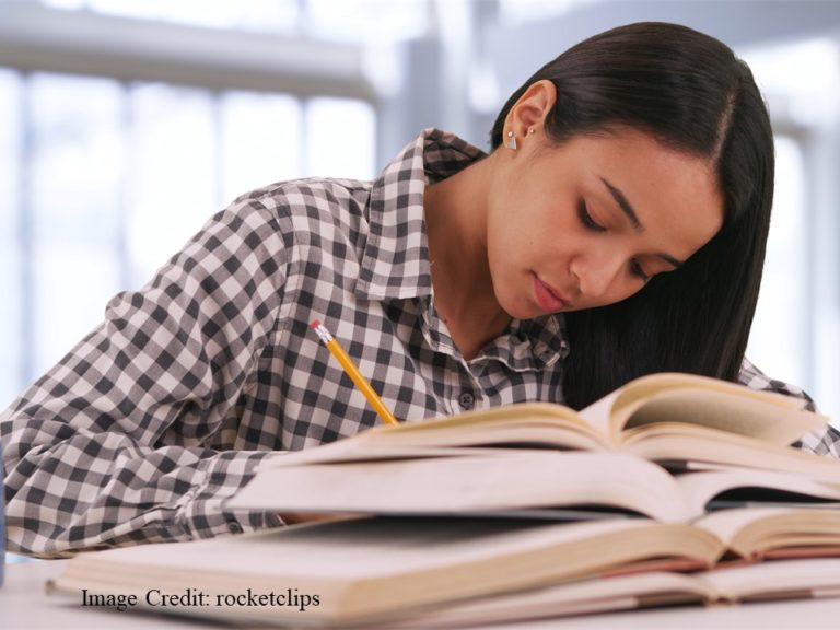 Hispanic female college student studying