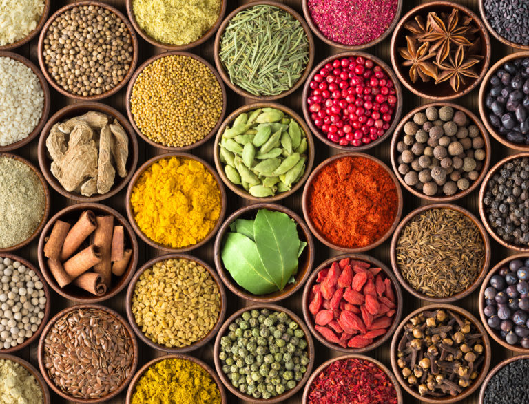 Colored spice background. Spices and herbs top view