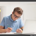 Student Doing Homework with Laptop