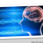 An image of a brain in a human head, with EEG waves in the background