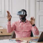 Man wearing Virtual Reality goggles, making gestures in the air