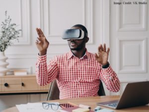 Man wearing Virtual Reality goggles, making gestures in the air