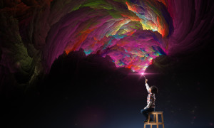 Child sitting on a stool creates fantastic color patterns in the air