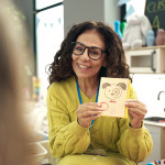 Middle aged preschool teacher having vocabulary lesson at kindergarten