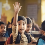 A primary school student wearing a backpack and sitting at a desk raises an eager hand.