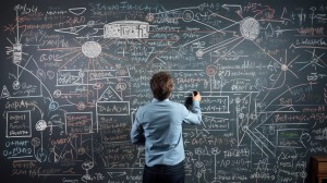 mathematics professor solving complex equations on a blackboard
