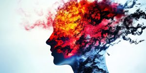 A silhouette of a human head in profile with vibrant, explosive colors - fiery reds, oranges, and yellows blending into cool blues and purples - flowing outward from the head like smoke or paint, suggesting stress and pain.