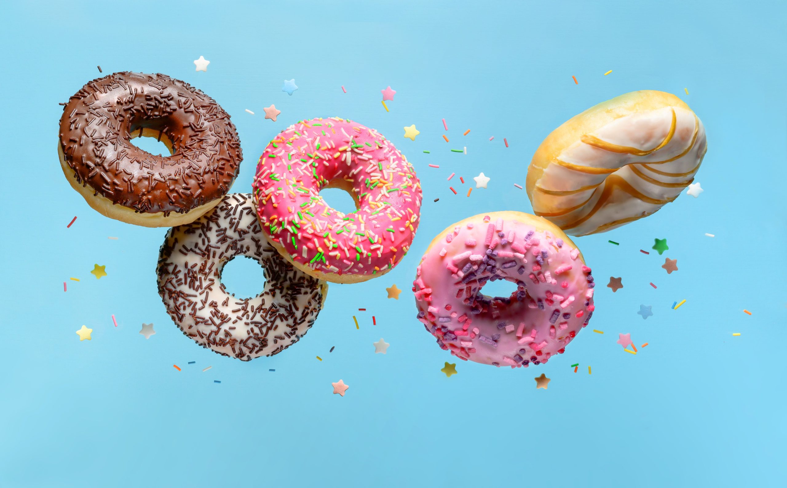 Several colorful donuts against a blue background